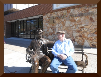 A sculpture of Abe Lincoln sitting on a park bench, with Bob Pendleton sitting alongside and looking at the sculpture
