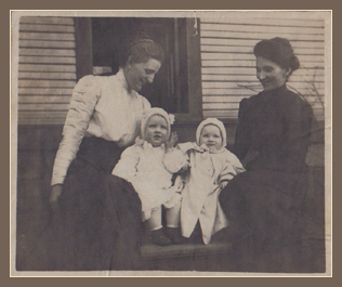 The lady in black is Ella Rowe Cadwell.  There is a friend and two babies.