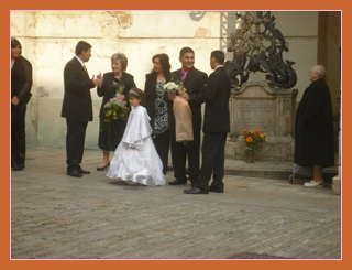 Guests gathering for a wedding at the oldest church in Bratislava,
with a little flower girl in a lovely white dress
