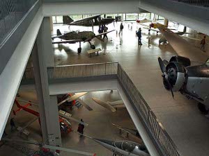 The photo shows planes on displays on two separate levels, taken from yet another, higher level of the museum