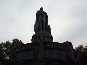 Visible in this picture as a silhouette against a cloudy sky, the statue of Bismarck seems dark and imposing