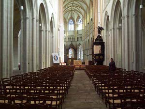 Looking up the central aisle of the cathedral, it is apparent that it bends slightly to the left.  The stone is very light, almost white, with pink stone accenting columns
