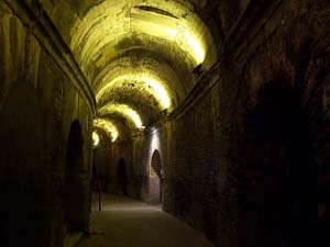 The interior has a wide curving corridor, with regular arches through which people can move; it has been lit by lights which cast a yellowish glow on the ceiling