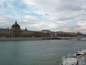 Wide, with docks and public buildings along the banks, the Rhone appeared greenish blue with a light blue sky peeking through many white clouds