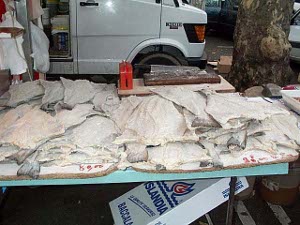 The cod is laid out on a table, one salted fish at a time.