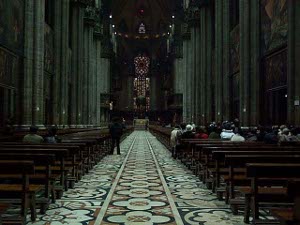 The main aisle of the cathedral is beautifully tiled, with a pattern in several colors that repeats itself up to the altar.  The surrounding benches are polished dark wood