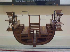 The two side paddlewheels are driven by laborers inside the boat who rotate a large axle which is fastened to the paddlewheels