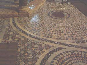 The floor of the basilica is decorated with an intricate pattern in expanding circles of lovely colored stone tiles