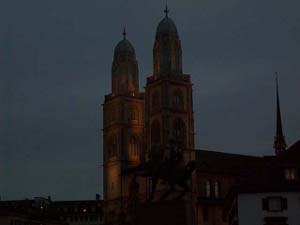 With two matching towers each topped by a cross, the Grossmunster is lit up in the early evening.