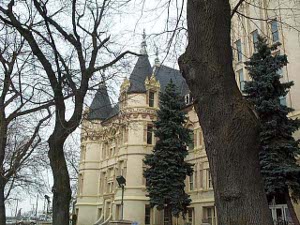 Set behind trees, the courthouse looks like a French chateau, in tan-colored stone