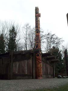 The totem pole is fashioned out of a very large, tall log, and brightly colored after carving