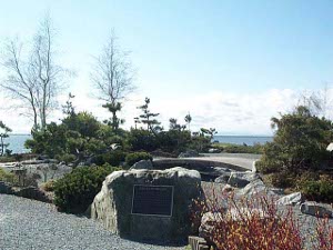 Nicely landscaped garden at Garry Point Park, with large dedication plaque in bronze mounted in a stone