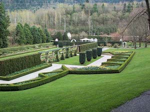 Geometric shapes and tightly trimmed hedges, large and small, with formal garden paths and carefully manicured lawns define one of the formal garden settings at Minter Gardens