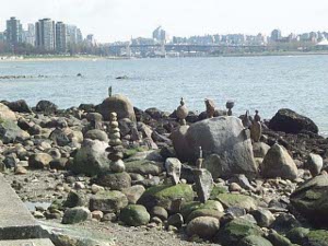 Passersby have carefully piled stones on stones to build fanciful towers near the shore
