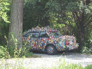 The car is decorated with hundreds of cans glued to its top, bottom and sides