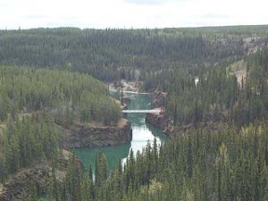 The photo overlooks Miles Canyon and the suspension bridge across the Yukon
