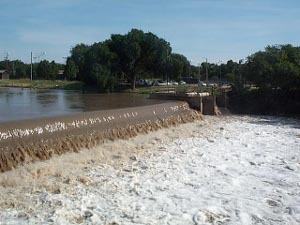 The muddy brown waters of the Wichita River turn into a tan, then pure white froth after a drop of perhaps three feet over a dam