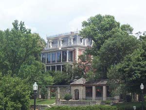 The red brick Victorian mansion with granite coigns has been modernized with glassed-in porches