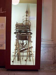 The wooden device appears improbably spindly, with legs akin to compass points and an exposed mechanism like clockwork.  About six feet tall, the contraption gave him his textbooks to read.