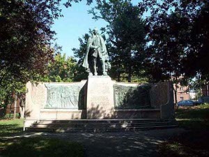 A heroic monument with a lifesize bronze statue on top of the center pedestal, flanked by two huge bas-relief bronzes, and inscribed with the names of all the founders of Watertown, this massive monument stands in an infrequently visited park.