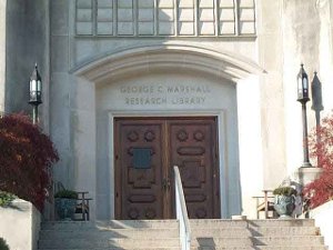 At the top of the stairs to the white stone building, the sign above the wide double oaken doors reads 'George C. Marshall Research Library'