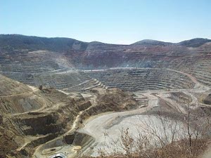 The picture shows a vast open pit, with terraced sides