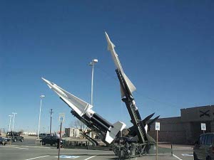 Two white missiles sit on Army Green launchers at Fort Bliss