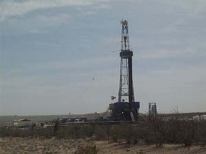 A lone oil derrick is digging a well