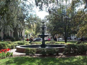 A lovely fountain, with three cascading dishes, sits in the middle of a Savannah city square.
