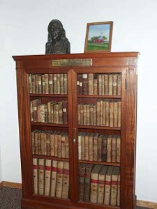 The oak bookcase with glass doors holds the old collection given to the town at the direction of Benjamin Franklin