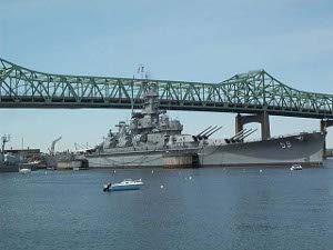 Under the green steel bridge floats the USS Massachusetts, a WW II combatant
