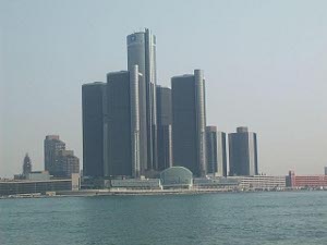 Looking like a scene from a futuristic planet, the General Motors Headquarters, a complex of tall, rounded, dark-colored skyscrapers, rises like a mountain across the Detroit River from Windsor.