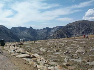 at 12,000 feet we are well above tree line; the path is rocky and barren, and many other treeless mountain tops are visible