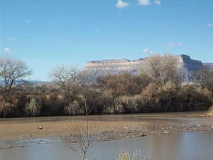 wide and flat, the Green River looks like a muddy spot in this November dry season.  A mesa rises in the background