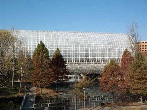 A huge white cylinder marks a greenhouse bridging a pond at Oklahoma City's conservatory