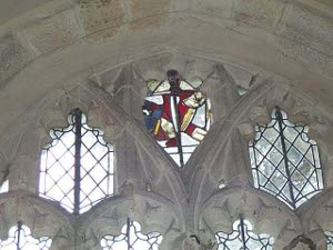 The uppermost window in Creed parish church has old stained glass