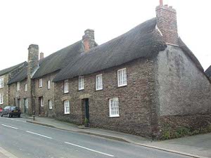 Two adjacent buildings in the tiny village of Polgooth, each about 60 x 30 feet, have old thatched roofs