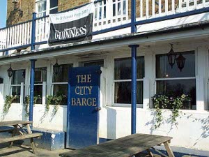 With a white front and blue trim, the door to the City Barge pub is steel to prevent flooding.