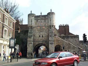 Bootham Bar, a defensible gate through the walls surrounding York is built out of stone and topped with towers