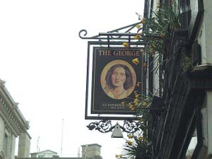 Suspended over the door, the pub sign has a reproduction of a painting of George Eliot, the writer