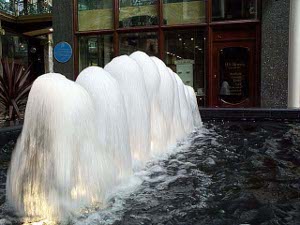 A gorgeous fountain features nine plumes of foamy white water falling back on themselves into a pool of water