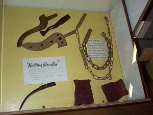 A display of hand-made wooden knitting sheaths and wool chains used by miners and their families to knit goods to sell for cash