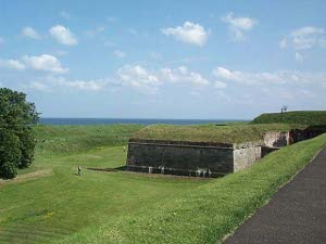 The ramparts are huge: high above the surrounding land with thick stone houses and wide grassy fields about.  In the distance is the North Sea.