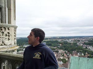 Already far above the roof, Dan pauses to have his picture taken before climbing further up the tower steps