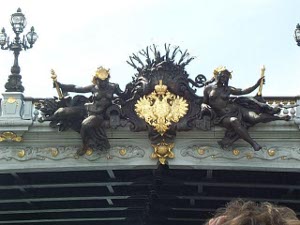 The decoration on the bridge is in black and gold, and features two figures and the double-headed eagle in gold in between.