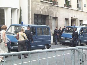 Two blue police vans have brought a squad of riot police to keep order at a labor union demonstration