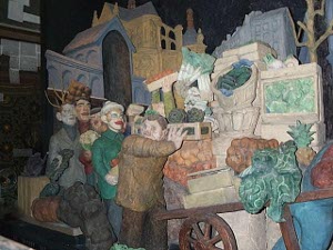 The sculpture shows men and women guiding a heavily laden wagon to the market, now closed.