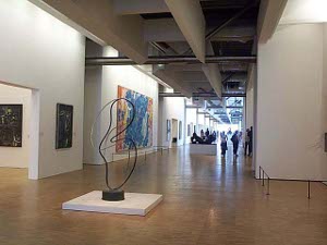 The large galleries feature plenty of floor space for the visitor to position himself to get a good view of the art.  White walls and modern tubular steel beams