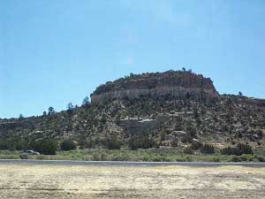 The Nevada rock is colored grey and brown, much darker than the Utah rock.  The butte rises another 30 feet above a 200-foot hill