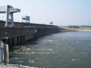 In this view the length of the dam stretches into the distance, with water swirling around the intake gates.